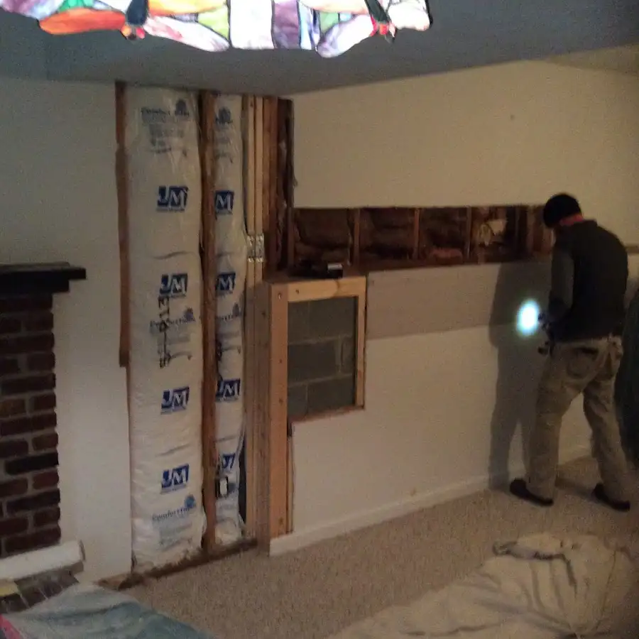 Restoration technician inspecting water damage in Marion